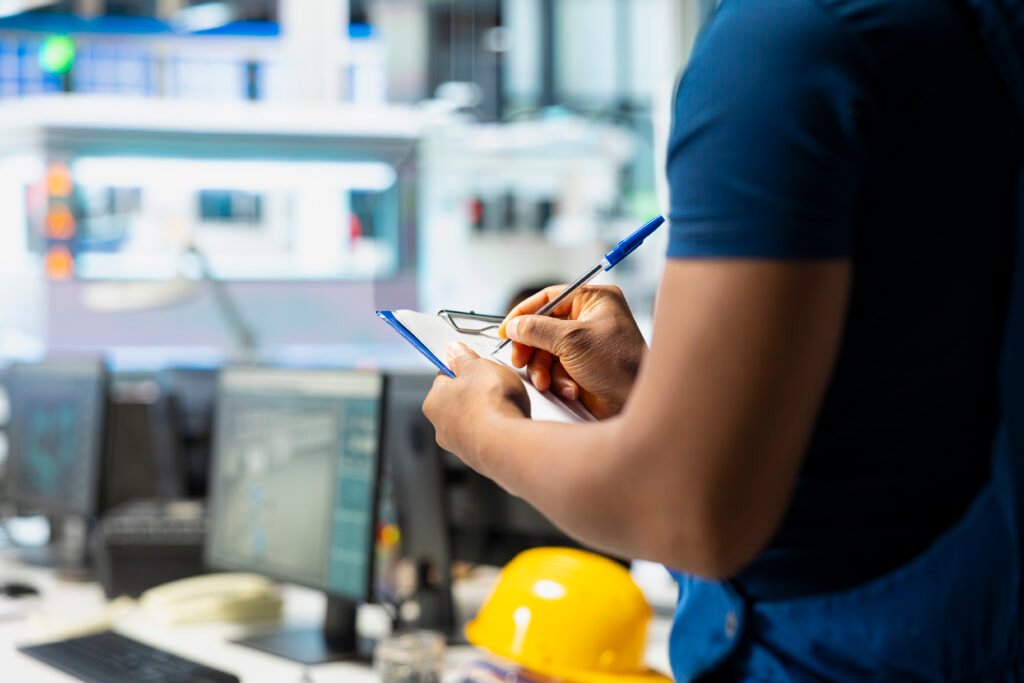 Solar panel manufacturing plant researcher taking notes on files,